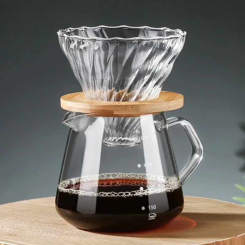 Clear glass coffee maker with wooden lid on a gray background