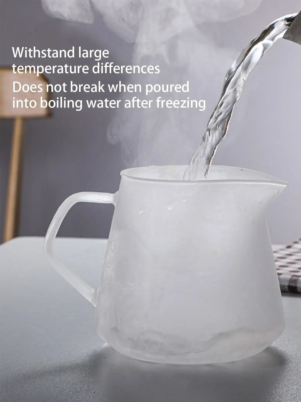 White glass pitcher with steam rising from it on a gray surface.