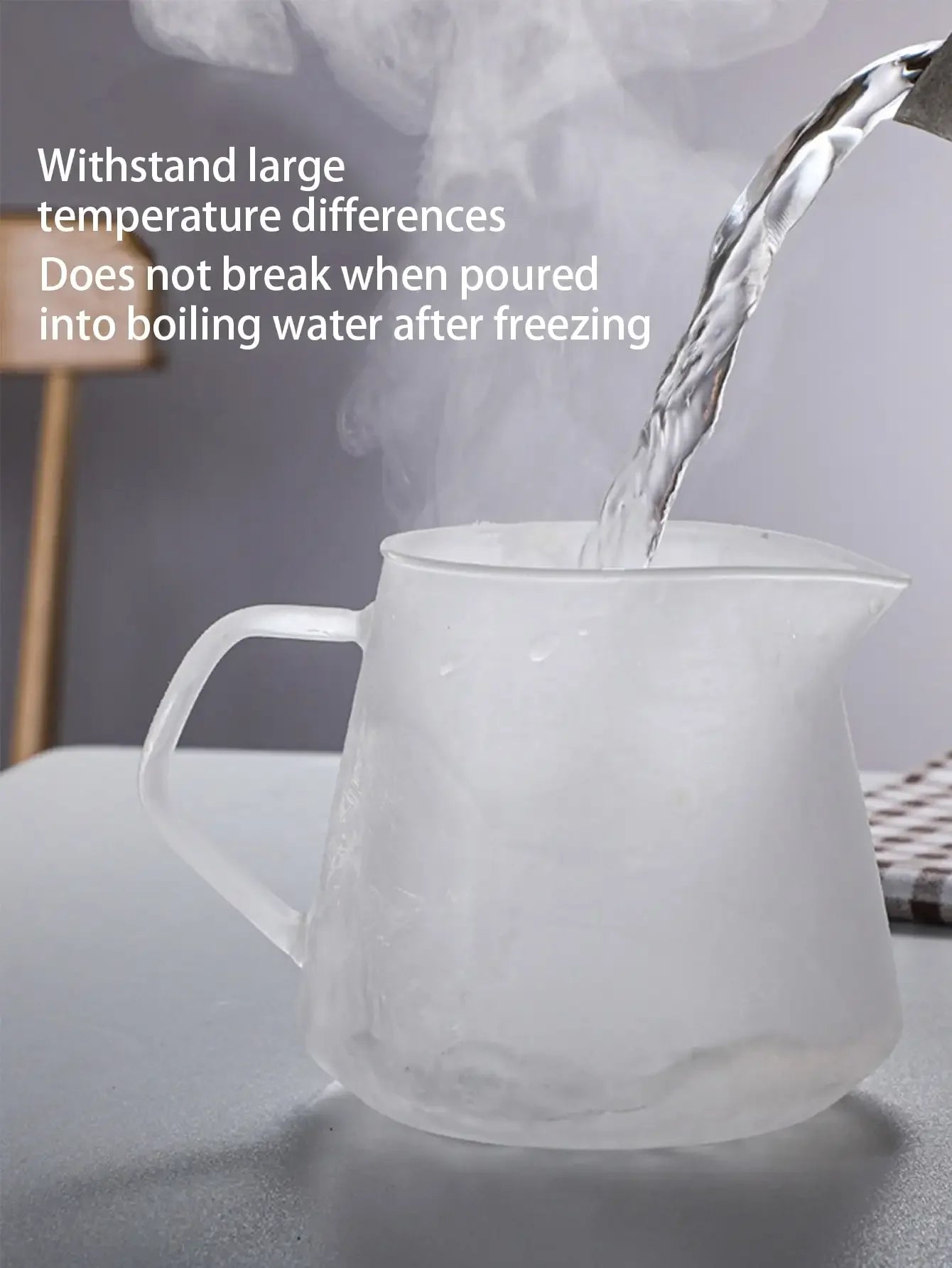 White glass pitcher with steam rising from it on a gray surface.