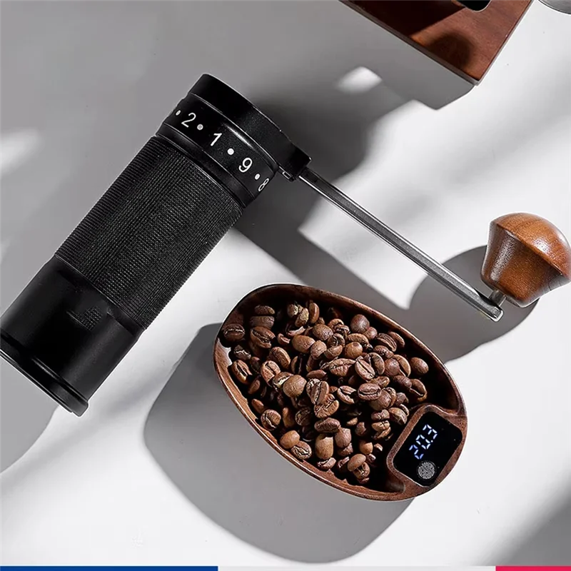 Coffee grinder with a digital display and coffee beans on a white surface