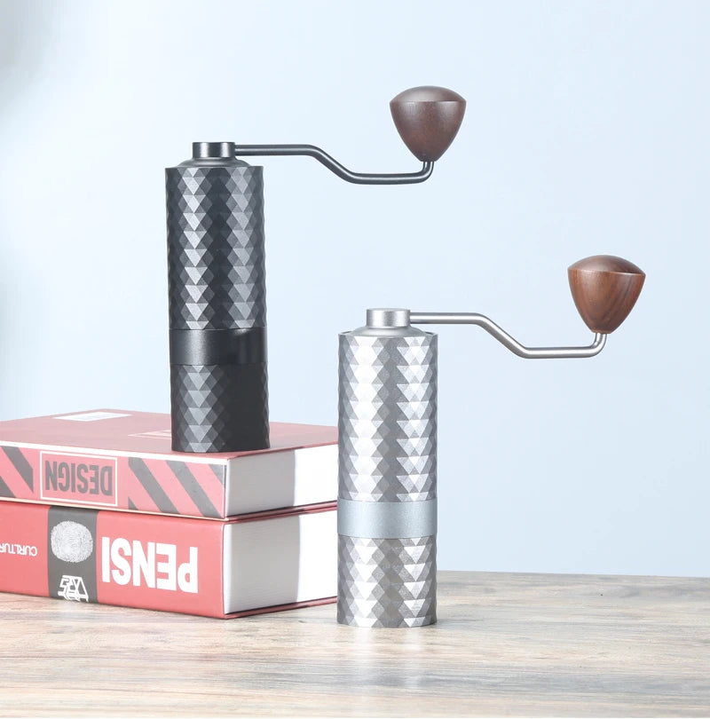 Two manual coffee grinders on a light blue background